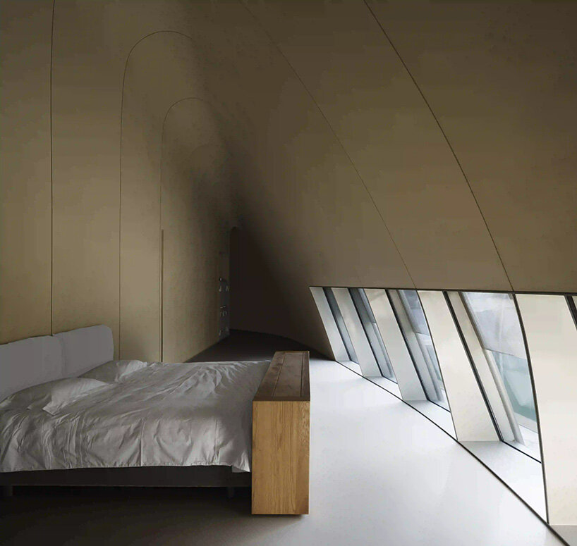 tapered tunnel-like openings appear carved into the sand and shell structures