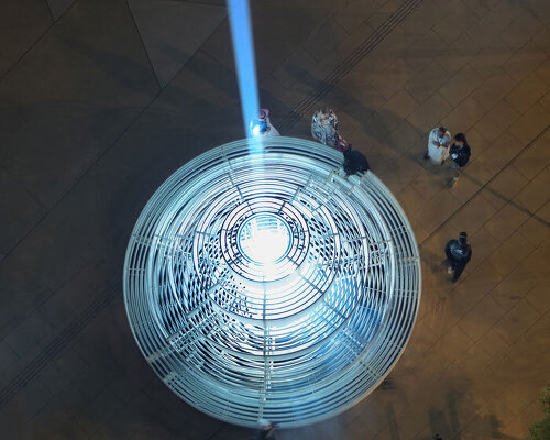 reflective pyramidal monument emits sky-tracing beam of white light in saudi arabia