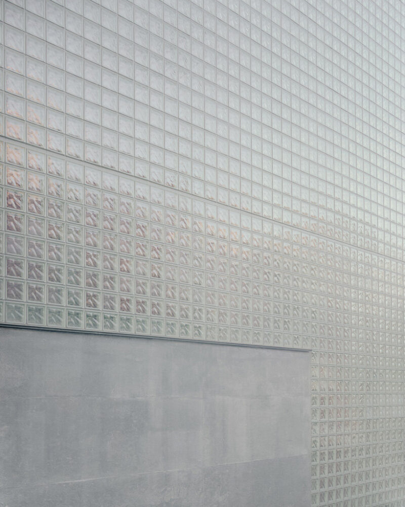 the glass block facade follows the curvature of the street-facing elevation