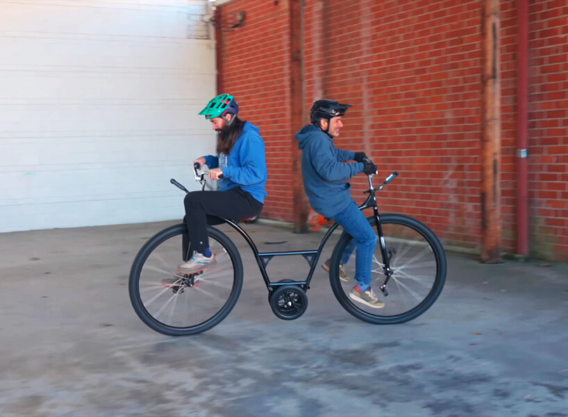 two identical high-wheel bicycles joined at their frames, facing opposite directions