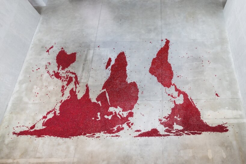 Mona Hatoum covers the concrete floor with translucent red glass balls arranged in the shape of a world map