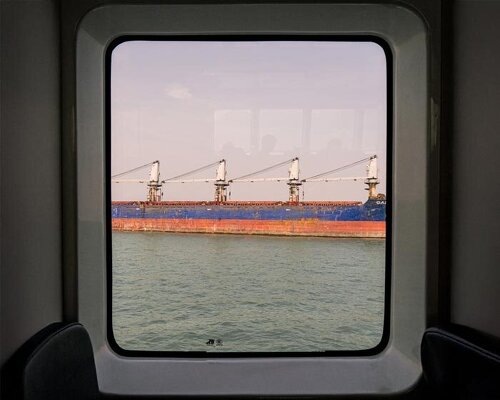 photographer captures cargo ships passing by on his ferry ride home