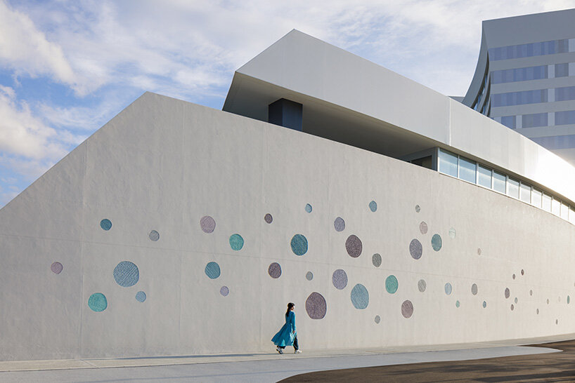 a perforated facade at the hotel’s base introduces subtle marine motifs