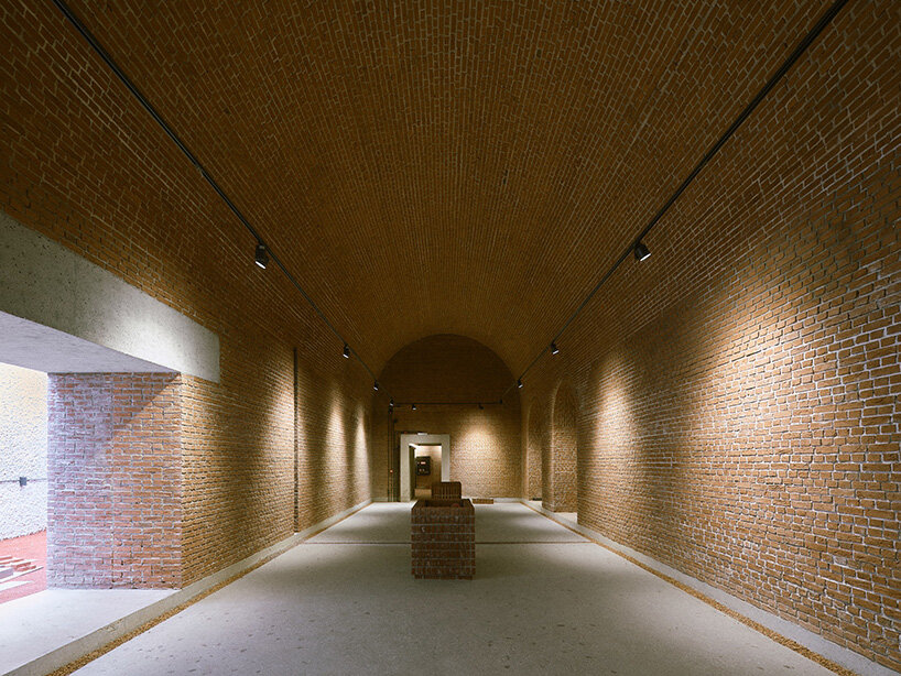 a planted courtyard appears between thick masonry walls