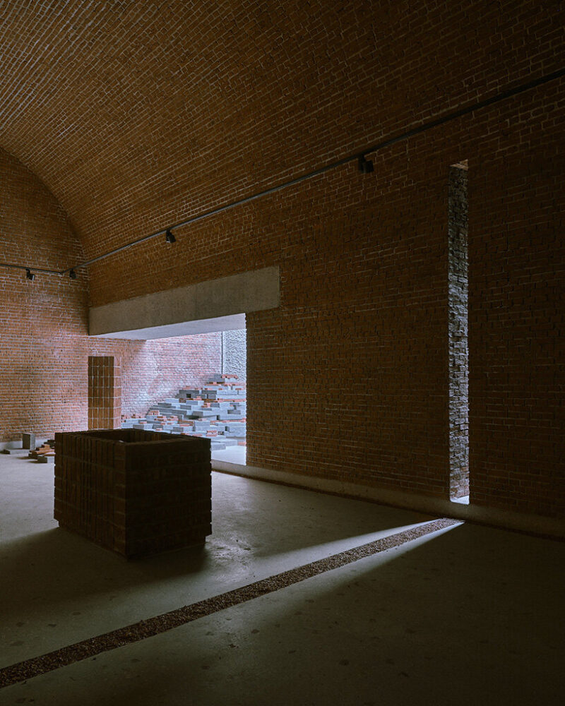 the arched brick ceiling forms a protective shell over the exhibition route