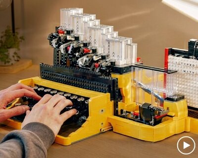 functional LEGO typewriter punches letters onto reusable board to write messages