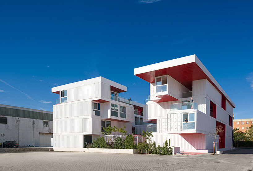 the incubator’s fragmented massing reads as a cluster of reused containers under a shared roofline