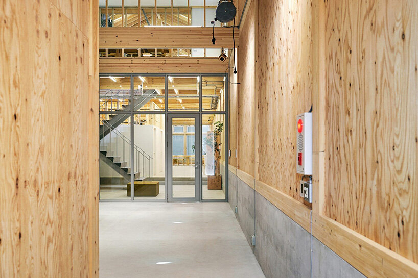 a corridor-like circulation space runs along the building’s depth