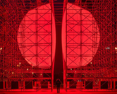 SpY's monumental divided sphere installation illuminates xi’an in bright red light