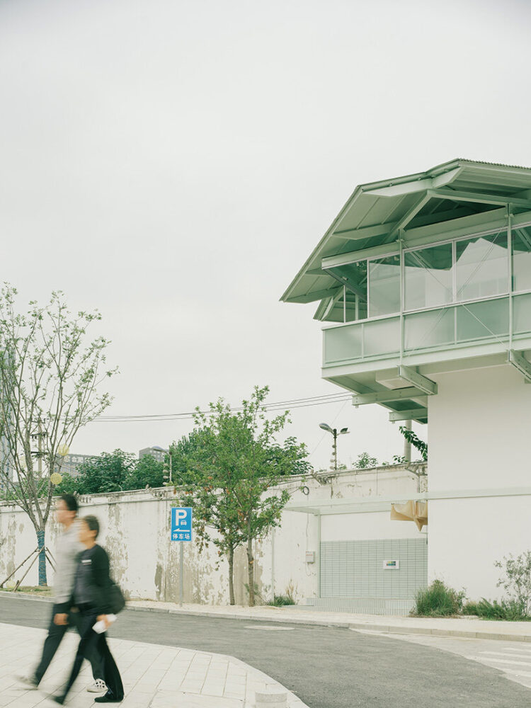 the elevated volume reads as a light insertion above the former prison wall