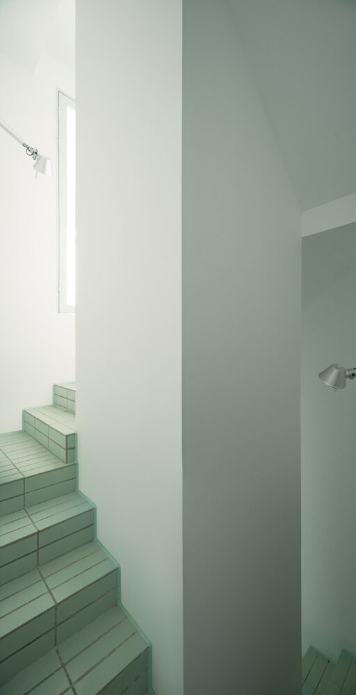 the stairwell acts as a narrow vertical connector between the two levels