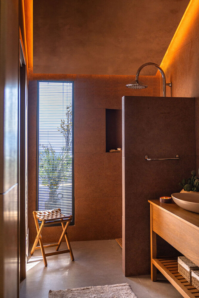 the master bathroom faces the second-floor roof terrace, bringing in light and views through a narrow window
