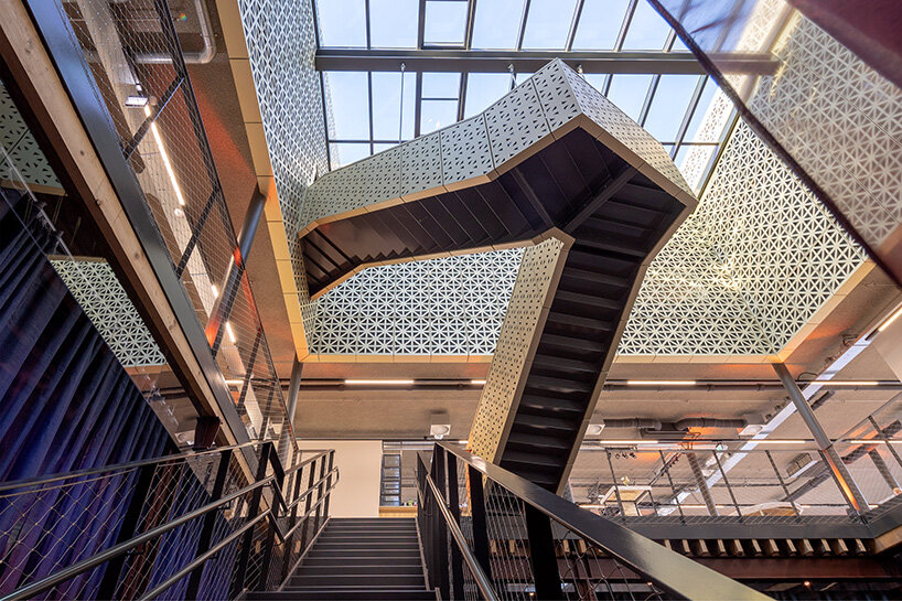 the folded metal stair volume is clad in patterned panels