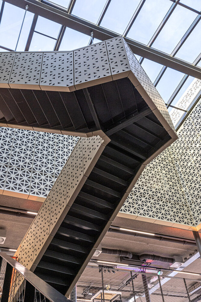 a sculptural staircase unfolds beneath the skylit atrium 