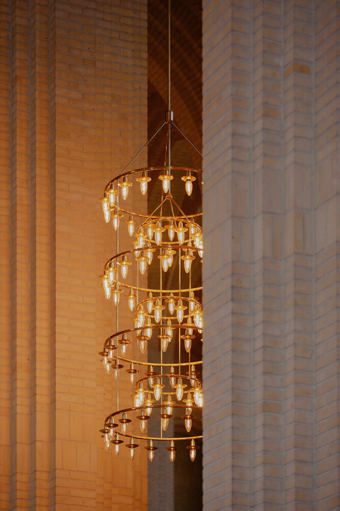 delicate light fixtures contrast with masonry