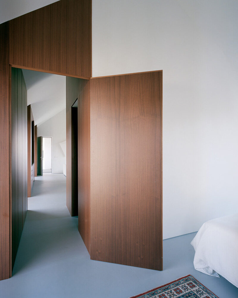 timber partitions define bedrooms along the linear interior layout
