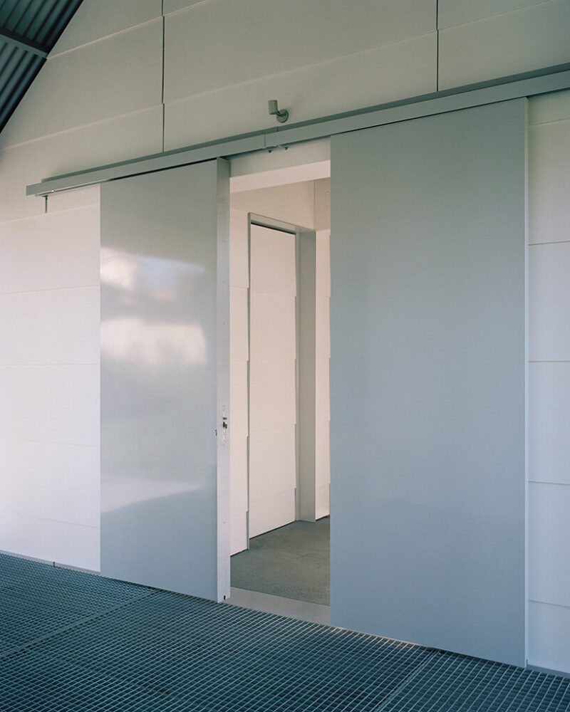sliding steel doors open the prefabricated volume onto the elevated metal deck