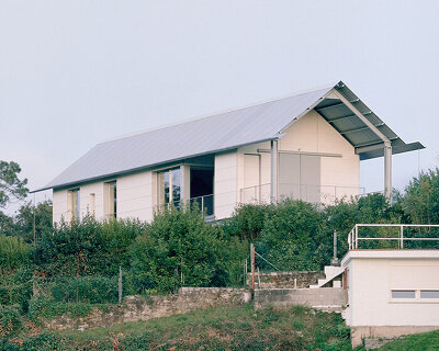 HANGHAR assembles steel-framed prefab residence in 48 hours on sloped spanish plot