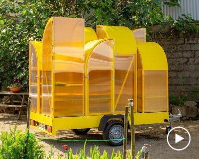 modular yellow greenhouse travels on wheels through portugal for seed germination
