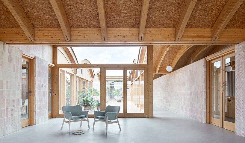continuous glazing frames views toward the central courtyard and reinforces cross ventilation