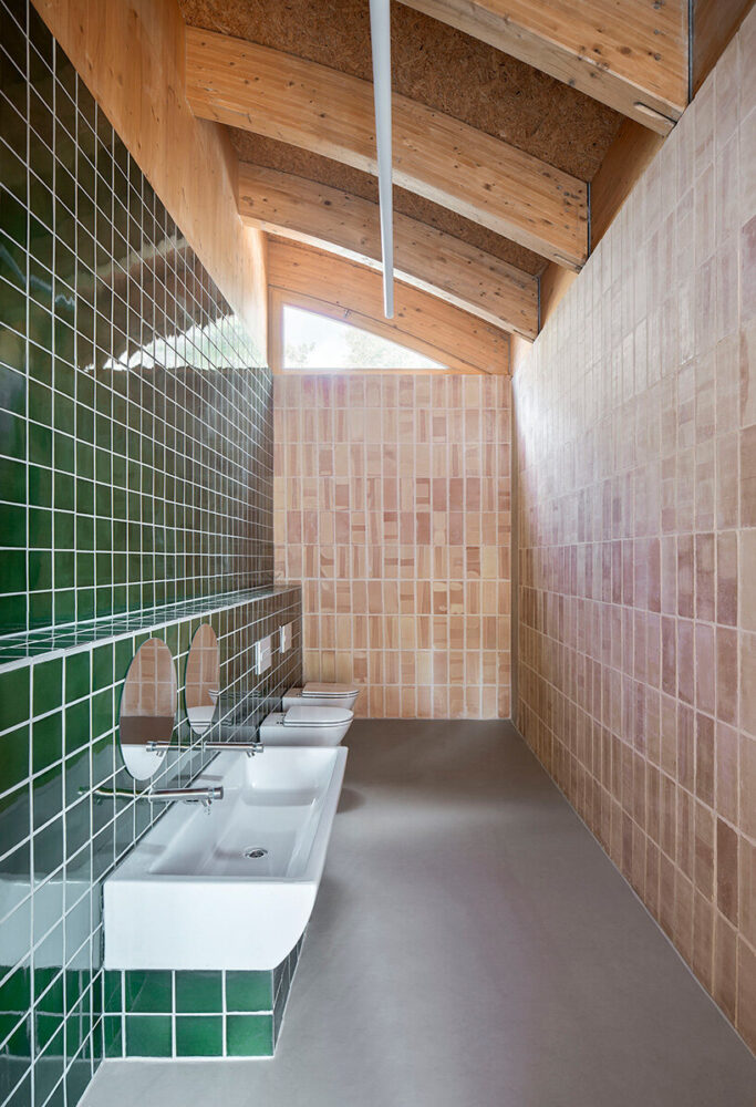 green ceramic tiles define the kitchen area