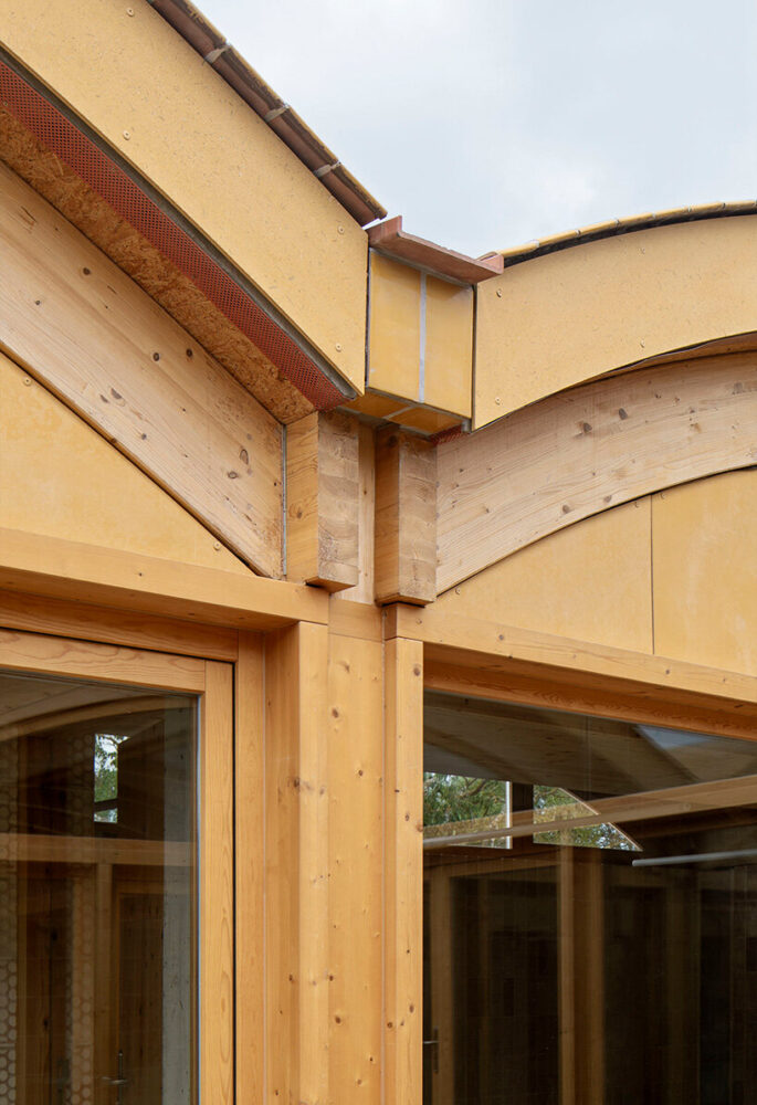 yellow-ochre ceramic roof tiles articulate the junction between vaulted bays