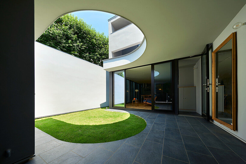 the horseshoe-shaped opening frames sky and treetops