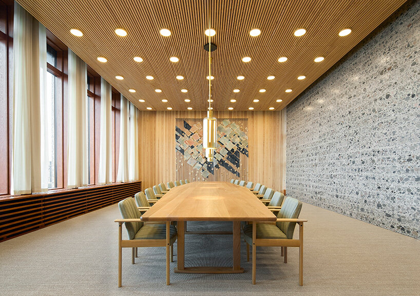 the prime minister’s meeting room combines stone, timber ceilings, and curated norwegian design pieces