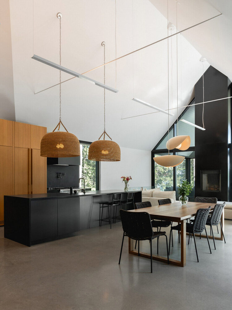 the living room, dining room, and kitchen open as a single, luminous volume