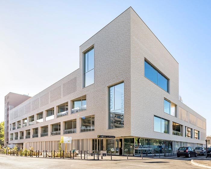stepped white brick facade wraps school group in france by brenac & gonzalez & associés