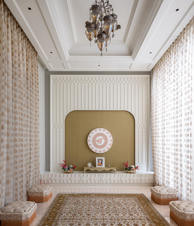 the sacred pooja room serves as a spiritual anchor, featuring minimalist filigree work