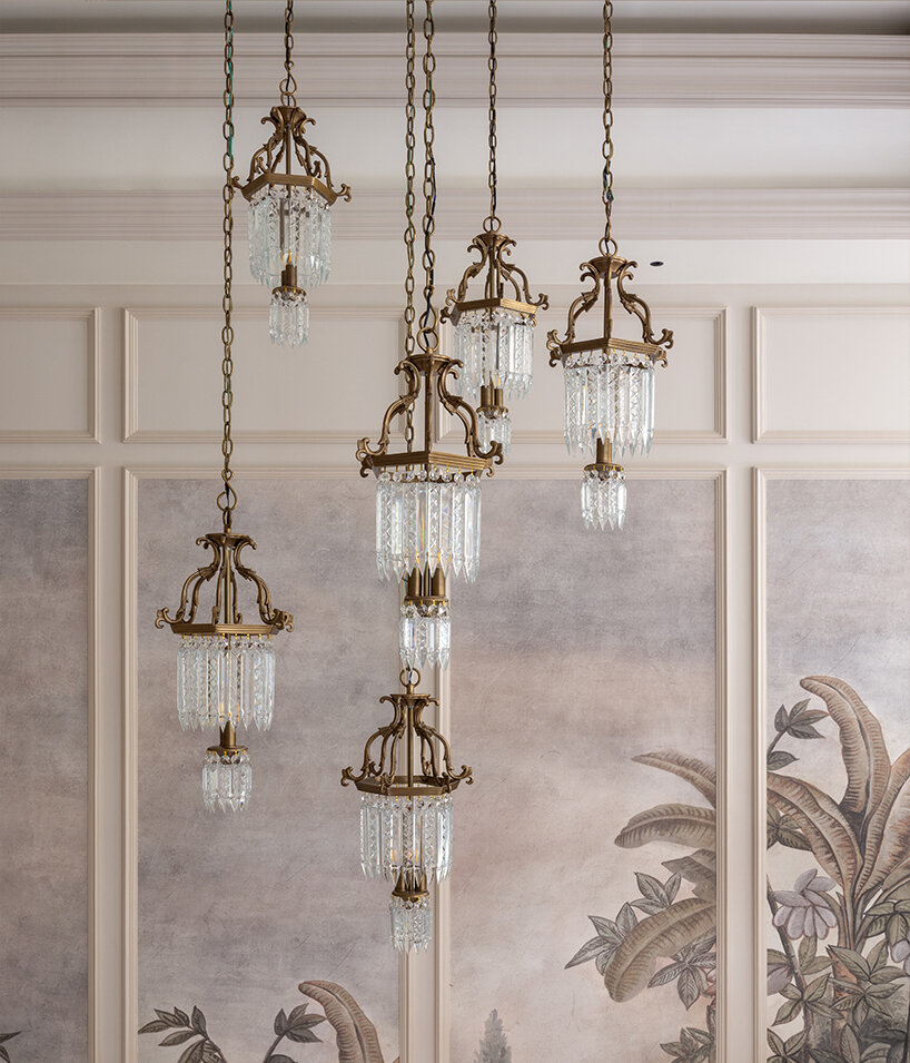 tiered brass and crystal statement chandeliers combines with expansive Chinoiserie murals