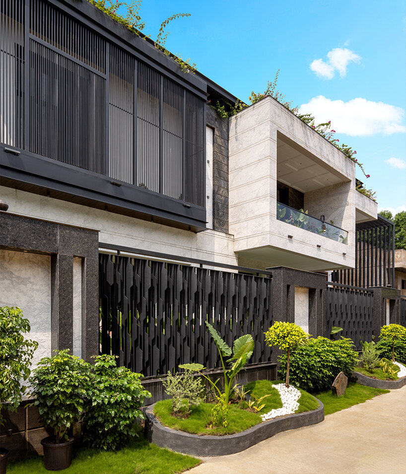 the fassade showcases a play of cantilevered volumes and textural depth