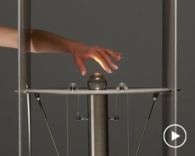 kinetic lighting activates mechanical movement in a sculpture of steel and glass