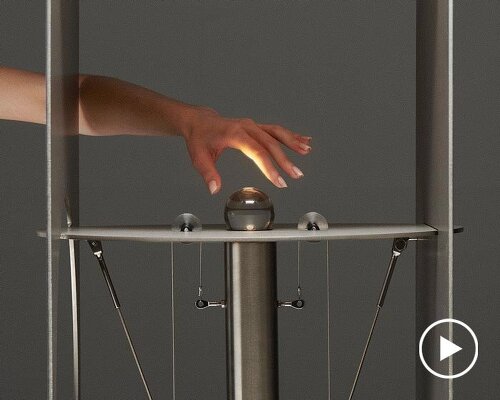 kinetic lighting activates mechanical movement in a sculpture of steel and glass