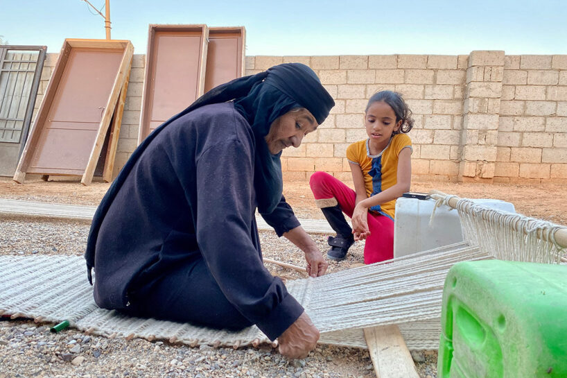 Terroir (process), 2022, a Bedouin woman weaving on the ground loom, with her daughter watching beside her -- the social epicenter of the community, image © Abeer Seikaly