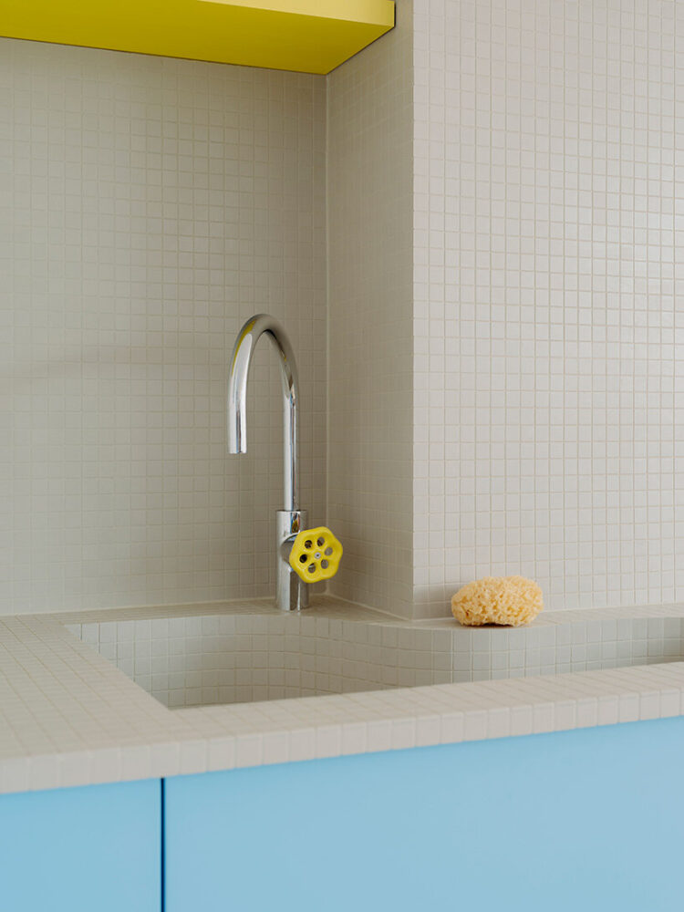 chrome fixtures and tiled surfaces emphasize the aquatic references