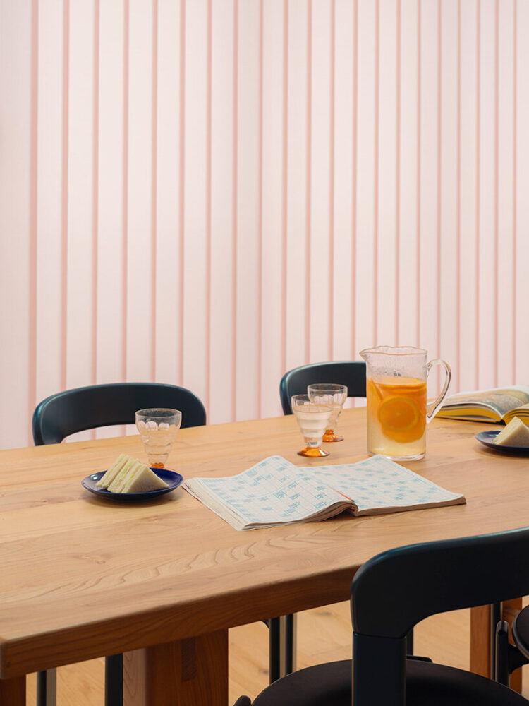 breakfast is set beneath soft pink blinds that diffuse the incoming daylight