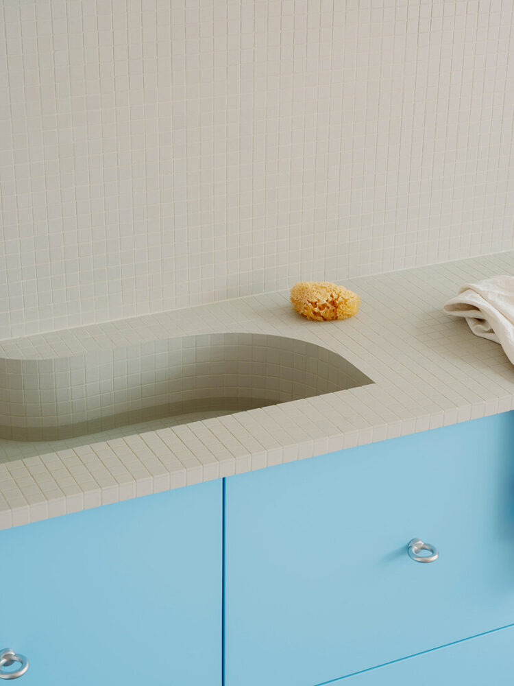 a long, linear composition of tiles, cabinetry, and open shelving