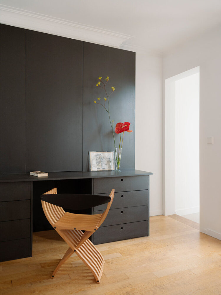 a built-in black desk creates a compact workspace