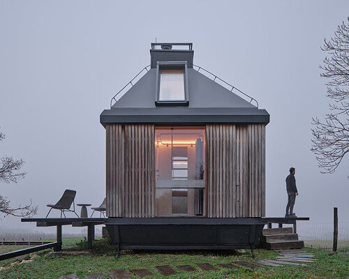 ark-shelter & archekta craft off-grid cabin with a fold-down facade in devín, slovakia