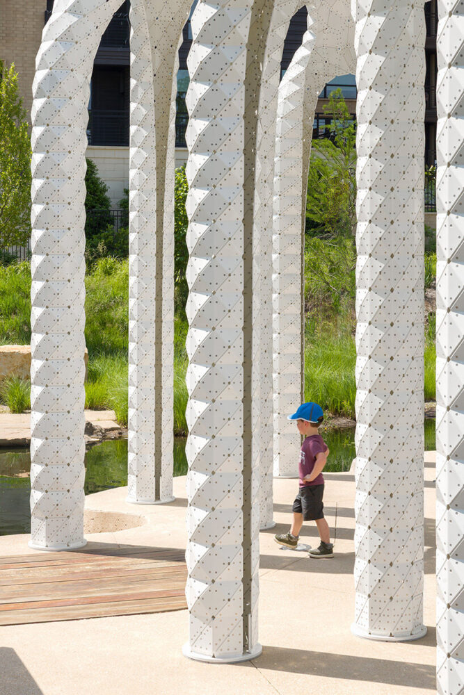 slender aluminum columns spiral upward to support the cocoon-like canopy