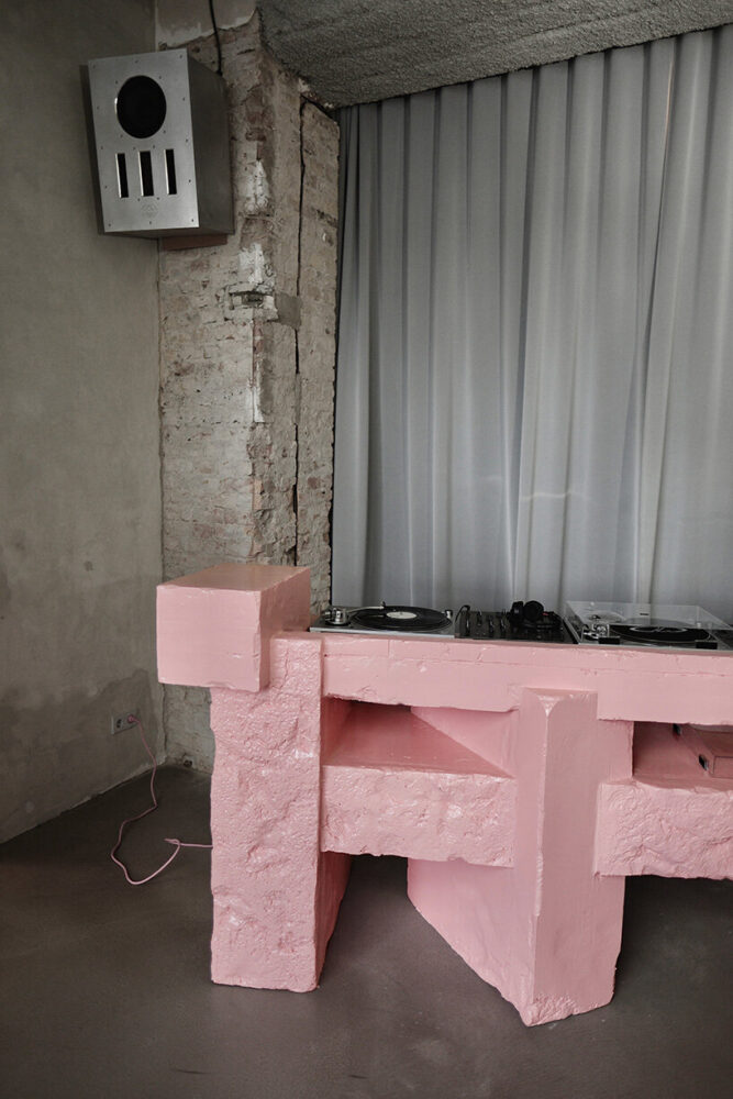 the Brutalist Pink DJ booth sits within the flexible event and streaming area