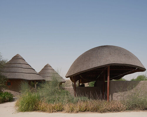 urko sánchez reinterprets african vernacular architecture in UAE with thatched pavilions