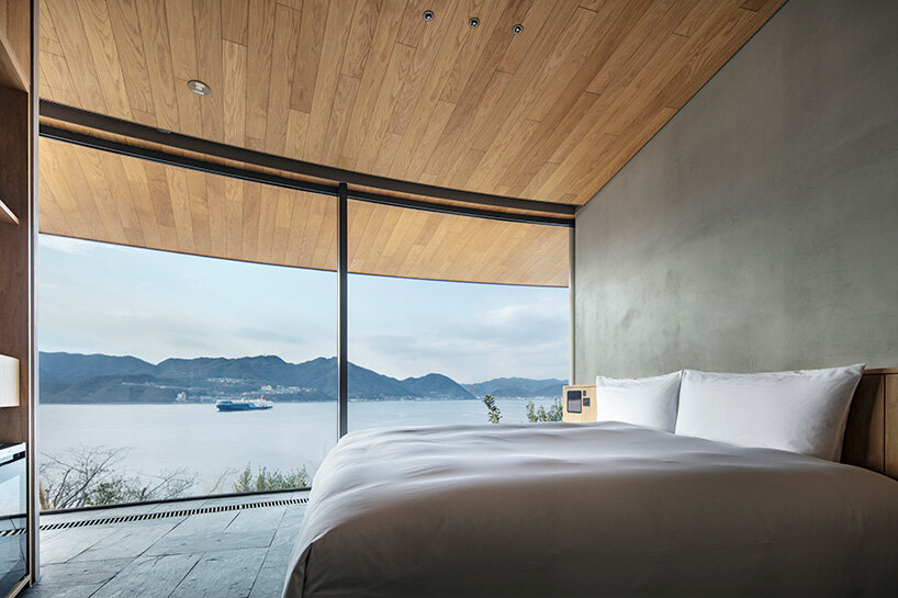 floor-to-ceiling glazing frames the layered seascape