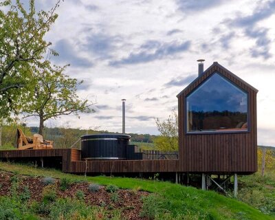 prefabricated timber micro-cabin extends living into the hungarian landscape