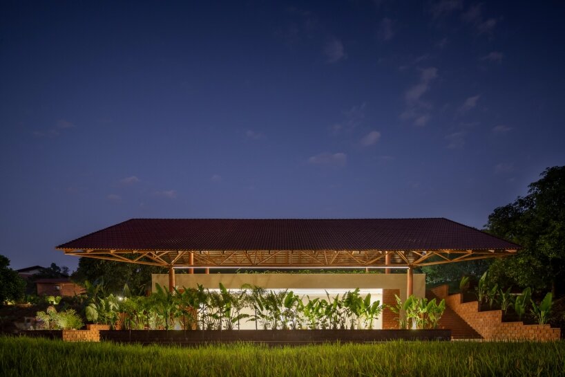 tiled floating Roof hovers over the built mass, camouflaged with earth and landscape