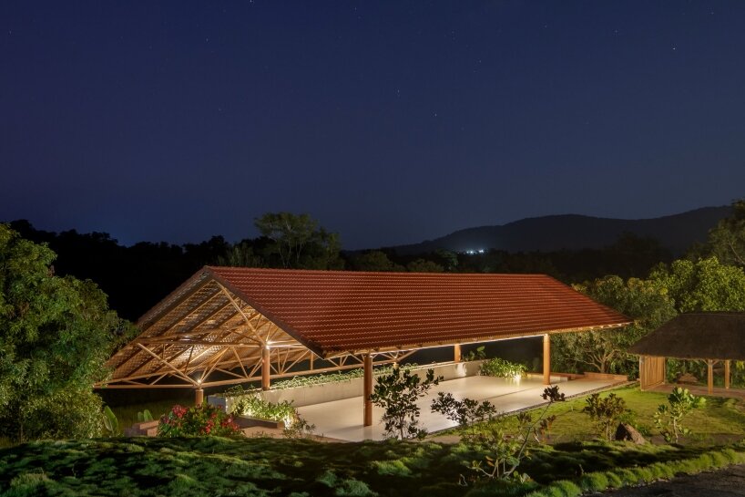 as evening sets in, soft lighting illuminates the pavilion, turning it into a calm and contemplative gathering space