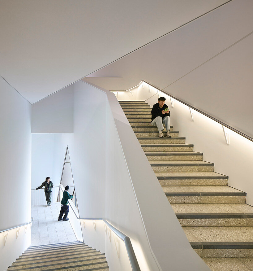 continuous staircases carve through the building