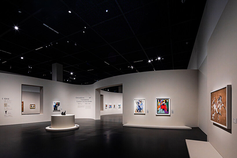 sculptures and paintings from the inaugural Cubists exhibition are displayed within restrained gallery interiors